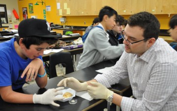 Parker Holman, right, talks about alcohol's impacts on the brain with a high school student.