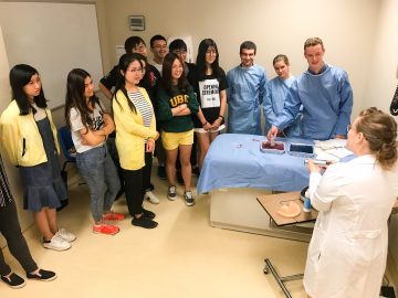 Nuclear medicine resident and volunteer instructor, Dr. Kathryn Darras, explains how to use ultrasound during a simulated breast biopsy.