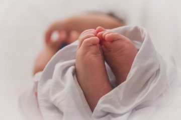 Closeup photo of a swaddled newborn baby