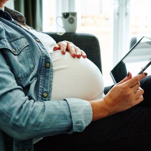 Pregnant woman using a tablet device