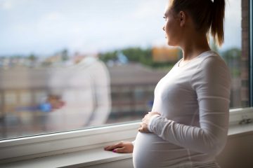 Bivalent vaccines are here – what it means for people who are pregnantImage of pregnant woman looking out of the window.