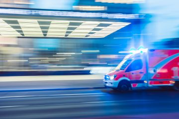 An ambulance driving down the street.