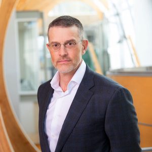 A headshot of Dr. Marco Marra, professor of medical genetics at UBC’s faculty of medicine, standing in UBC’s Michael Smith Laboratories.