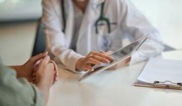 Shot of a doctor showing a patient some information on a digital tablet