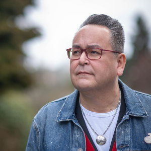 A headshot of Derek K Thompson - Čaabať Bookwilla | Suhiltun, Director, Indigenous Engagement in focus with a blurry background
