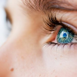 Close-up of a person's eye looking to the side.